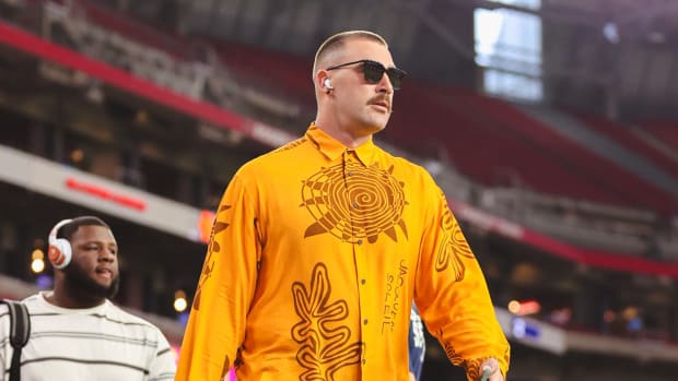 Travis Kelce walks onto the field before an NFL game.